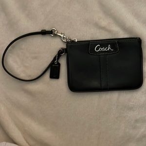 Gently used Coach black leather wristlet with zipper closure